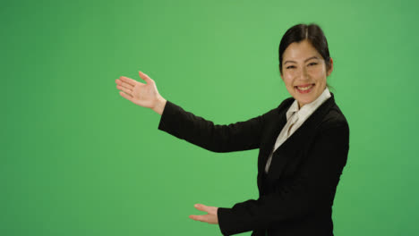 Businesswoman-gesturing-with-arms-on-green-screen